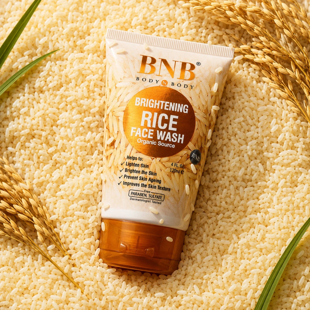 BNB Brightening Rice Face Wash surrounded by rice grains and wheat in a premium skincare product shot