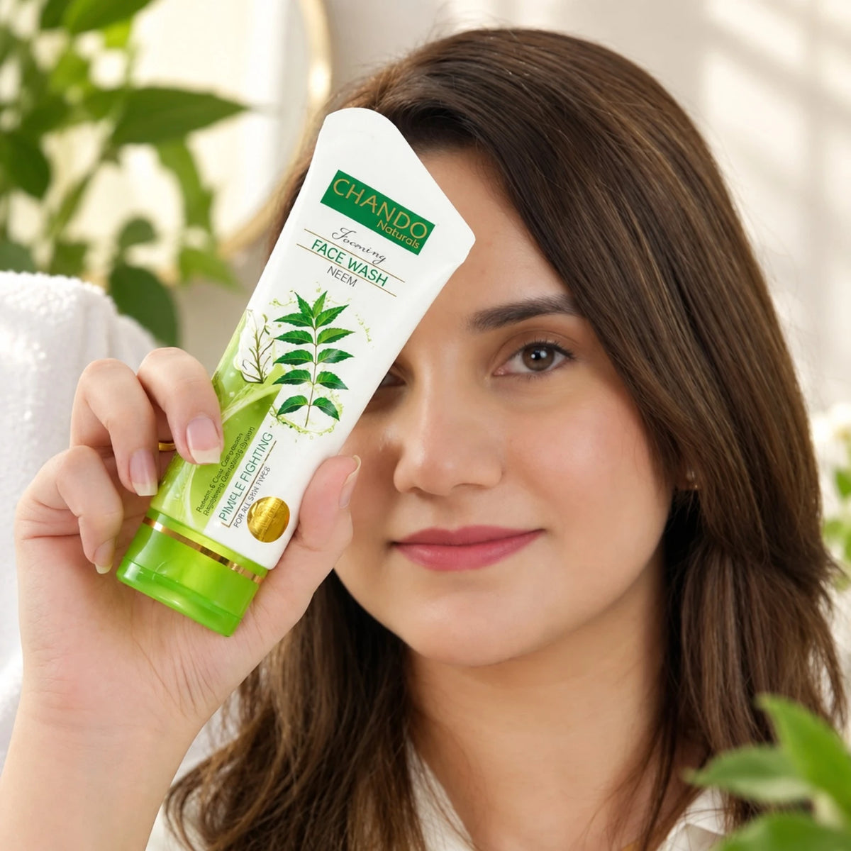 Chando Naturals Neem Pimple Fighting Face Wash 100ml held by a woman