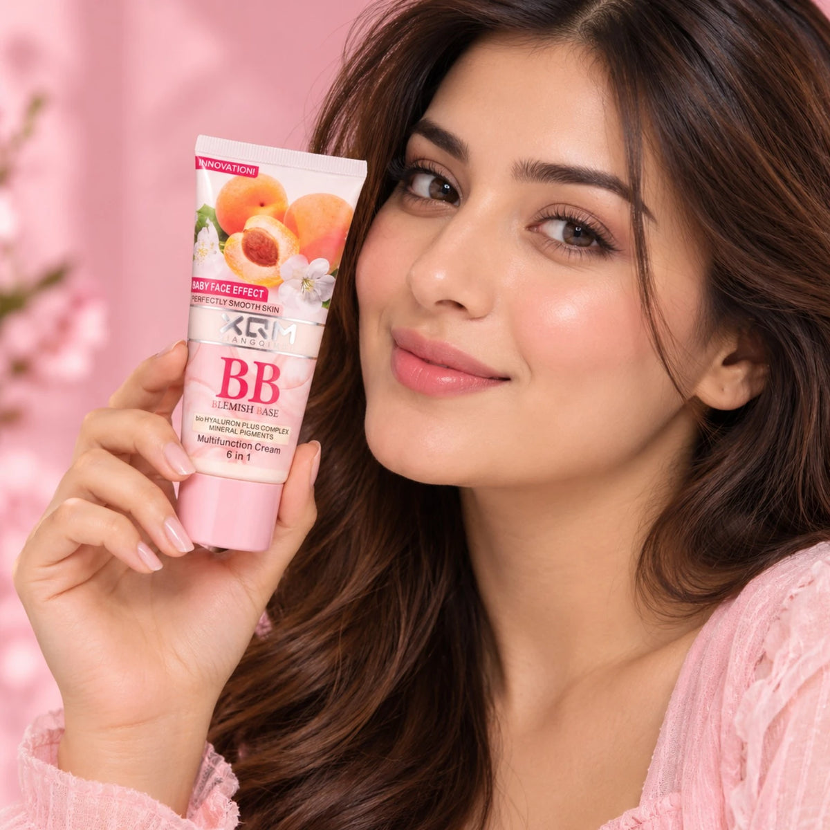 XQM BB Blemish Apricot Base Cream 65ml held by a woman as a makeup base